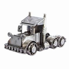 a metal model of a semi truck on a white background