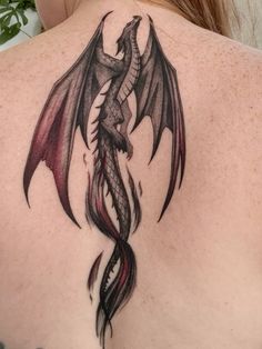 a woman with a dragon tattoo on her back