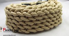 a close up of a rope on top of a white table with a black handle