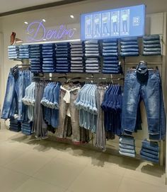 a display in a clothing store filled with lots of blue jeans