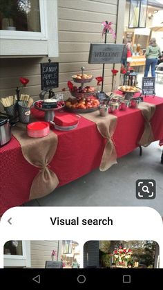 a table covered in red cloths with food on it and some signs that say visual search