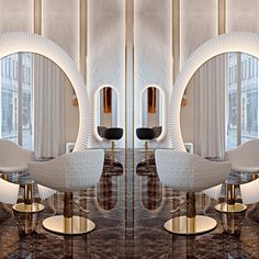 the interior of a modern salon with mirrors and stools in white and gold colors