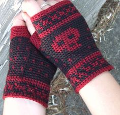 a person wearing red and black knitted arm warmers