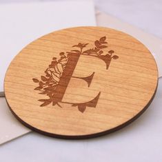 a wooden coaster with the letter e on it