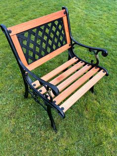 a wooden bench sitting on top of a lush green field