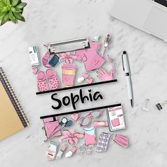 the word sophiia surrounded by various items on a white table next to a laptop