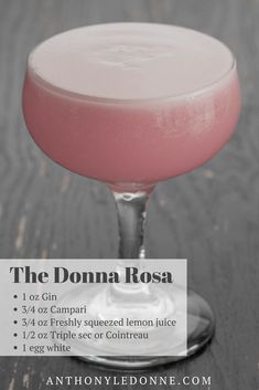 a pink drink in a coupe glass with a label on the side that says, the donna rosa