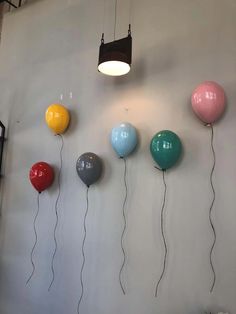 several balloons are hanging on the wall