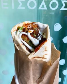 a burrito sitting on top of a brown paper bag