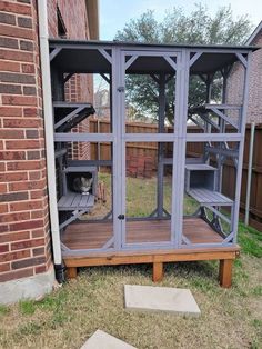 a cat house built into the side of a building