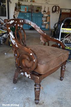 an old wooden chair sitting in a garage