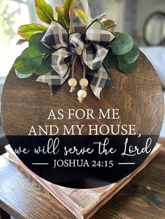 a wooden sign that says as for me and my house we will serve the lord