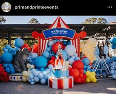 there is a carnival display with balloons on the ground and an elephant statue in the center