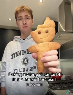 a man holding a teddy bear in his hand with the caption, baking my long distance bt into a cookie because i miss him