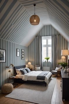 an attic bedroom with striped walls and wood flooring, white bedding, two lamps,