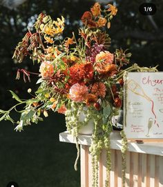 an arrangement of flowers is displayed on the ledge