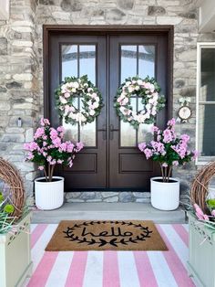 front door decorated with wreaths and pink flowers