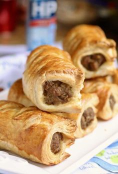 some sausage rolls are on a white plate