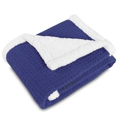 a blue and white blanket folded up on top of each other with a fluffy edge