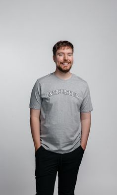 MrBeast smiles while wearing a grey t-shirt that says ENTREPRENEUR. His hands are in his pockets. Grow Your Business, Growing Your Business