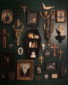 there are many framed pictures on the wall with skulls and other things around them,