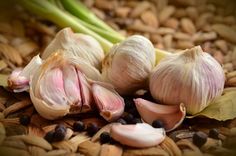 garlic and other vegetables are sitting on the ground