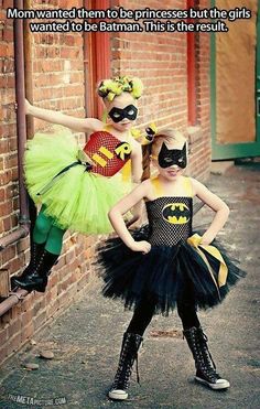 two children dressed up as batman and catwoman