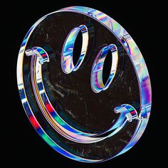 a smiley face made out of glass on a black background with the letter o in it's center