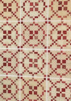 an old quilt with red and white squares on it