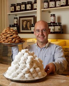 a man sitting at a table with some food on top of it