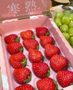 a box filled with lots of ripe strawberries