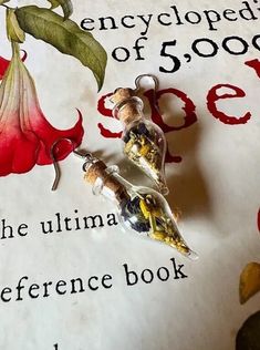 a close up of a book with a flower on it and a keychain