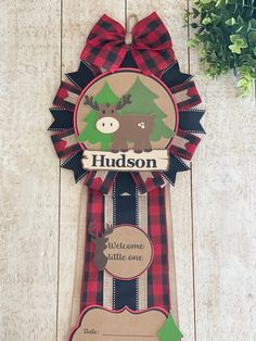 a ribbon with a moose on it is hanging from the side of a wooden wall