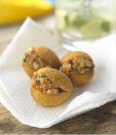 three small food items sitting on top of a napkin