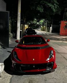 a red sports car is parked on the side of the road