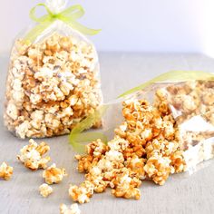 two bags filled with popcorn sitting on top of a table