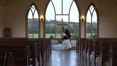 a bride and groom kissing in front of the alter at their wedding ceremony with an open window