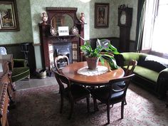 a dining room table with chairs and a potted plant