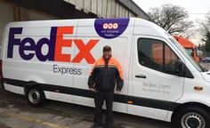 a man standing in front of a fed ex truck