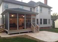 a screened in porch with stairs leading up to it