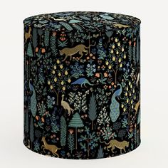 an artistically designed stool with animals and plants on it's sides, in black