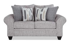 a gray couch with two pillows on it