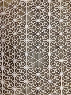 an intricate design on the side of a wall in a building with many different shapes and sizes