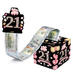 a roll of money sitting on top of a black and white box with the number twelve