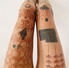 the legs are covered with tattoos and designs on their bodies, as if they were from different countries