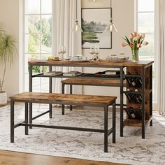 a dining room table with two benches and wine bottles on the shelf next to it