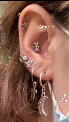 a close up of a person's ear with piercings attached to the side