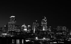 black and white photograph of city skyline at night