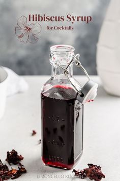 Bottle of hibiscus syrup with dried hibiscus flowers around it and the text Hibiscus Syrup for Cocktails on top. Hibiscus Simple Syrup Recipe, Margarita Simple Syrup, Hibiscus Cocktail, Pitcher Of Margaritas, Hibiscus Drink, Hibiscus Syrup, Simple Syrup Cocktails, Edible Rose Petals, Dried Hibiscus Flowers