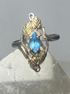 "Black Hills Gold ring leaves long topaz sterling silver women girls Size 8.75 Between a size 8.75 and a size 9 Weight 3.6g Length 1\" Width 3/8\" Thinnest part. 1/8\" Free Shipping & Free Postal Insurance Delivered in a Gift Box If you do not want the ring polished and want to leave the natural patina please let me know at the time of purchase as I do polish rings before I ship rings out. Thanks Free First Class shipping and postal insurance is included. If you want to upgrade to priority kindl Elegant Silver Leaf-shaped Ring, Fine Jewelry Topaz Ring Stamped 925, Hallmarked Topaz Ring In White Gold, Blue Topaz Hallmarked Ring, Hallmarked Blue Topaz Ring, Black Hills Gold Rings, Black Hills Gold, Black Hills, Turquoise Ring